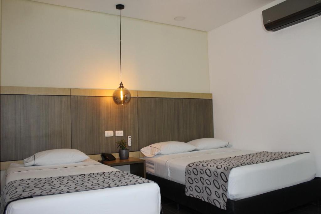Postel nebo postele na pokoji v ubytování Hotel Merlott Lleras