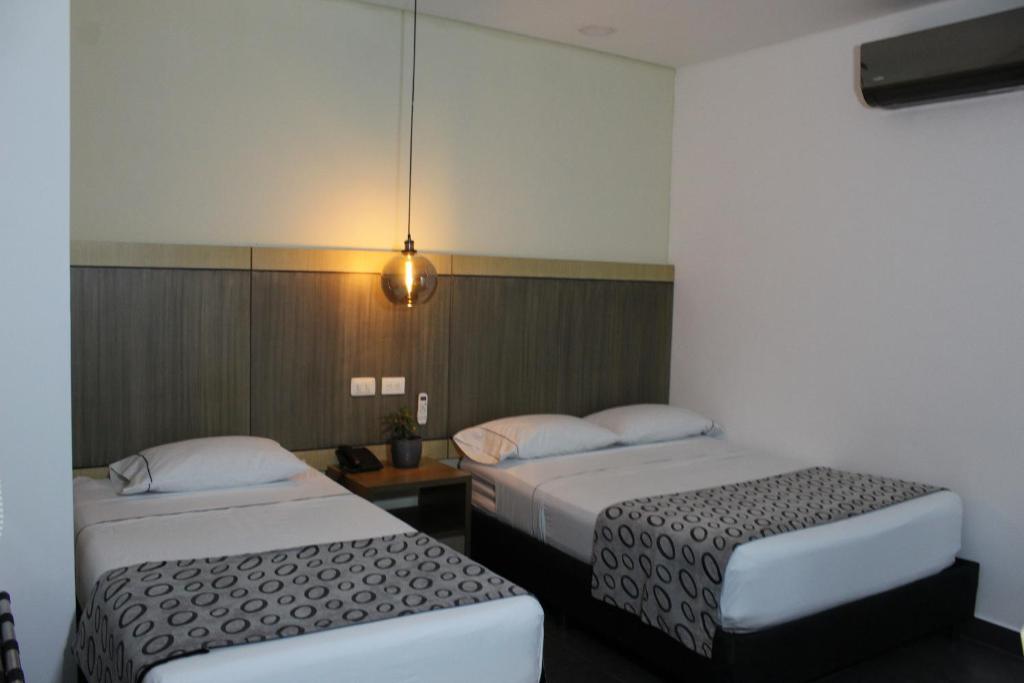 Postel nebo postele na pokoji v ubytování Hotel Merlott Lleras