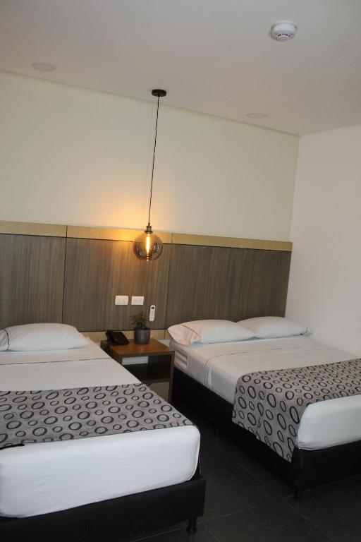 Postel nebo postele na pokoji v ubytování Hotel Merlott Lleras