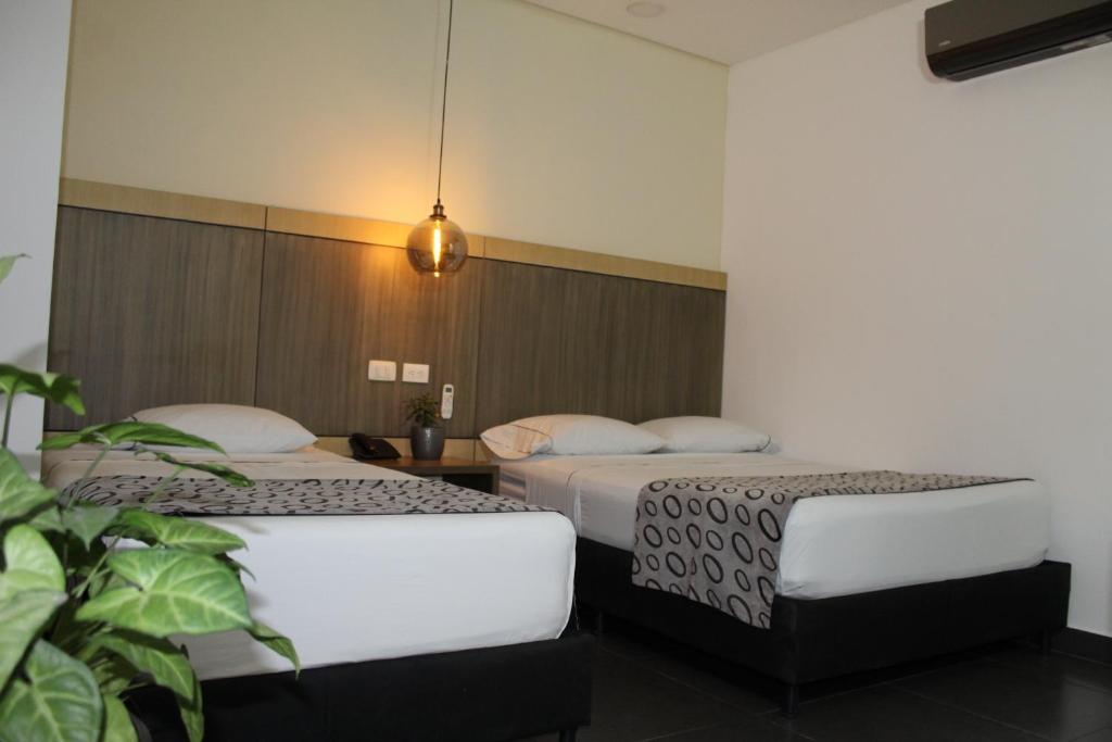 Postel nebo postele na pokoji v ubytování Hotel Merlott Lleras