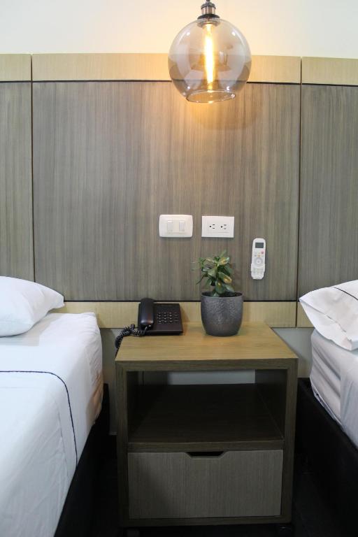 Postel nebo postele na pokoji v ubytování Hotel Merlott Lleras