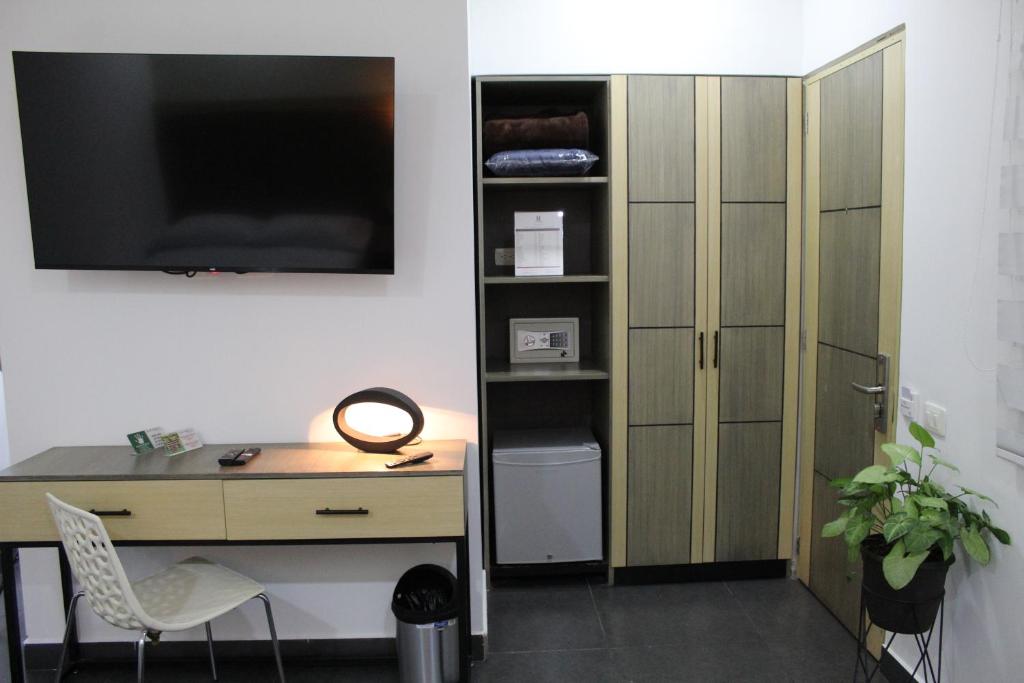 TV a/nebo společenská místnost v ubytování Hotel Merlott Lleras