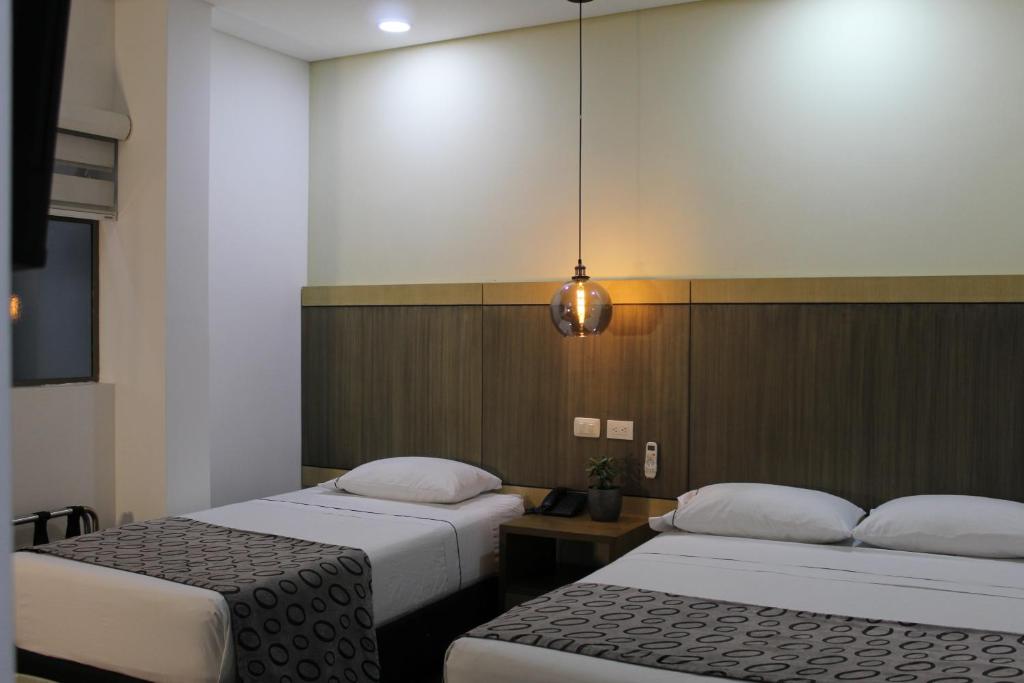Postel nebo postele na pokoji v ubytování Hotel Merlott Lleras