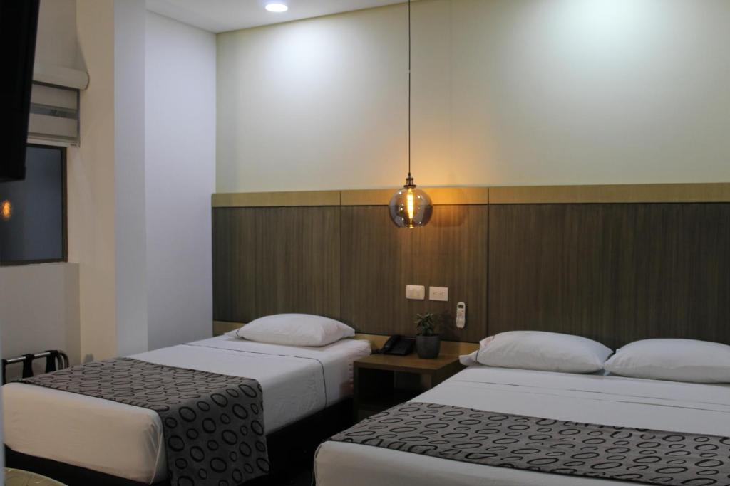 Postel nebo postele na pokoji v ubytování Hotel Merlott Lleras