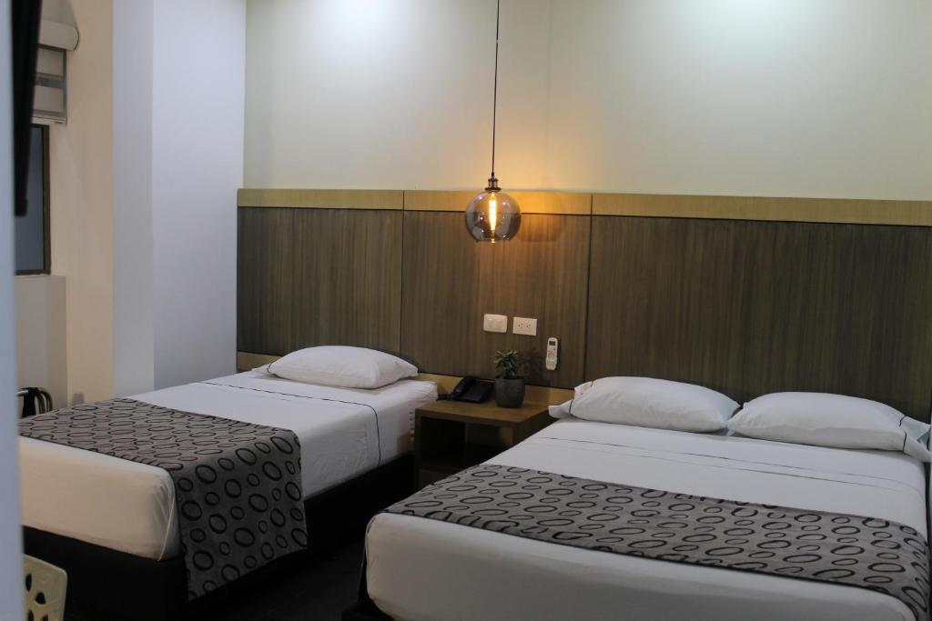 Postel nebo postele na pokoji v ubytování Hotel Merlott Lleras
