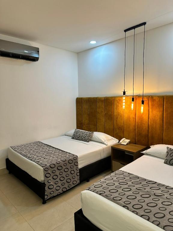 Postel nebo postele na pokoji v ubytování Hotel Merlott Lleras