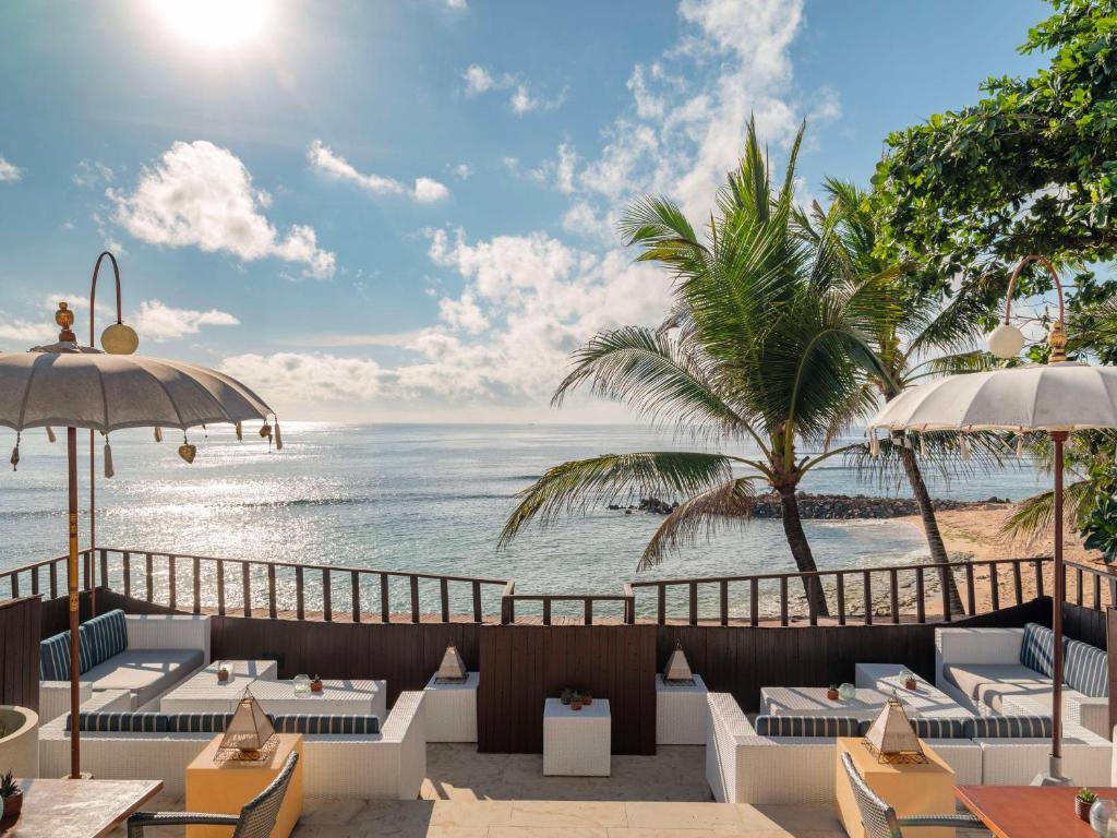 a restaurant with a view of the ocean at Hilton Bali Resort in Nusa Dua