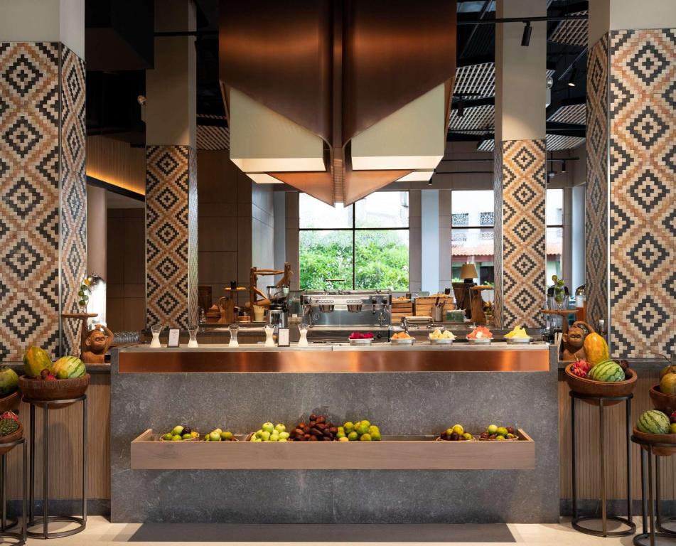 a kitchen with a bunch of fruit on display at Hilton Bali Resort in Nusa Dua
