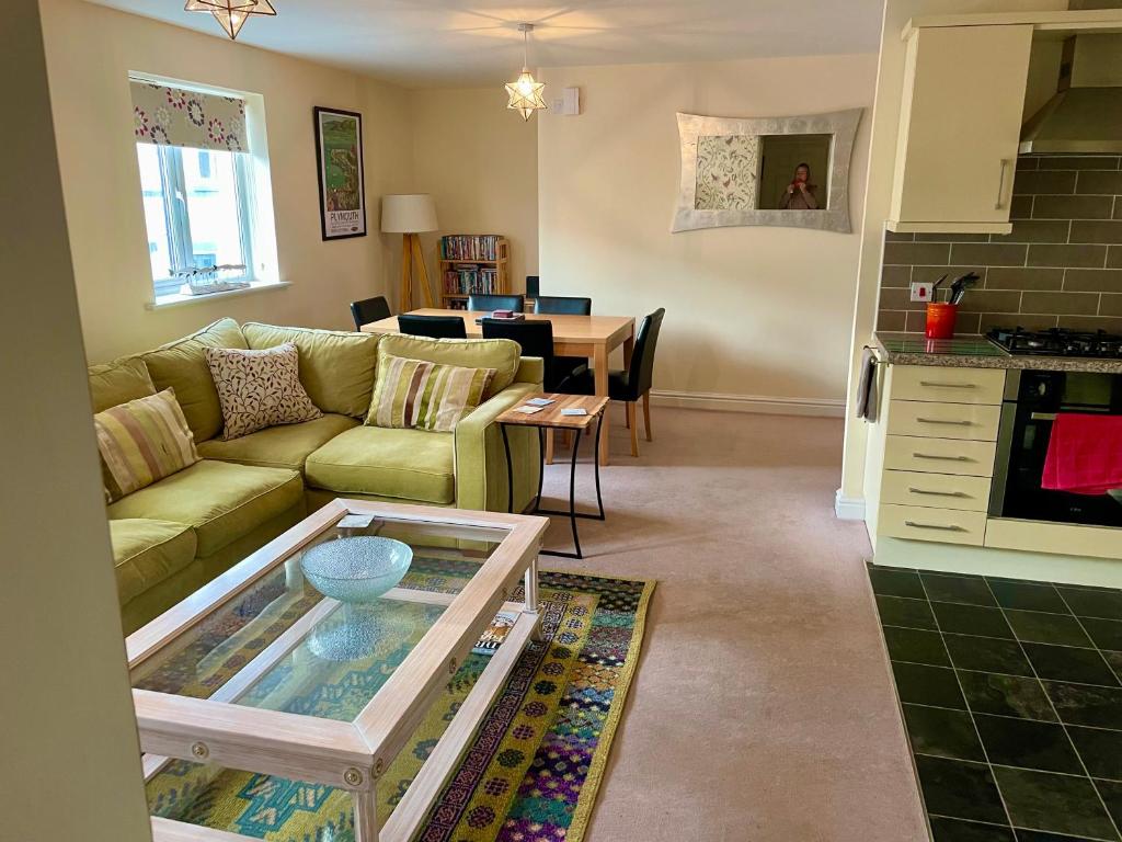 a living room with a couch and a table at The Coach House in Par