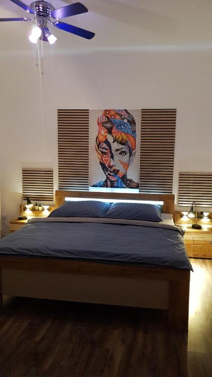 a bedroom with a bed with a painting on the wall at Chez D&D in Eschweiler