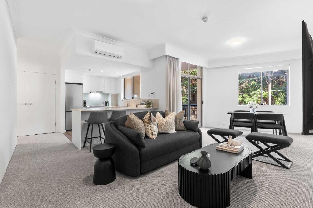 a living room with a couch and a table at Camperdown Cozy Corner 1 in Sydney