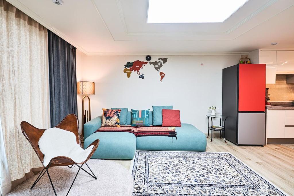 a living room with a couch and a chair at Haeundae Beach Bexco in Busan