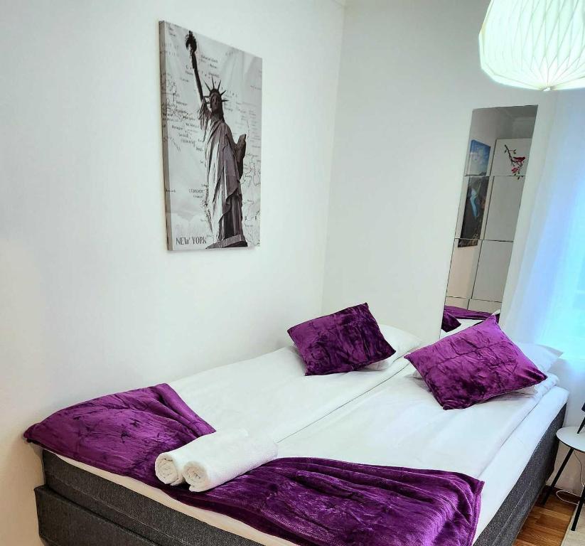 a bedroom with a large bed with purple sheets at Stavanger City Center Wood Ap1 in Stavanger