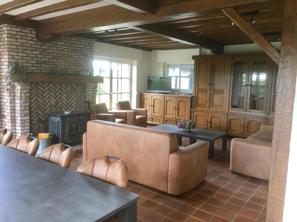 a living room with couches and a fireplace at Holiday Home in Groede near Sandy Beach in Groede