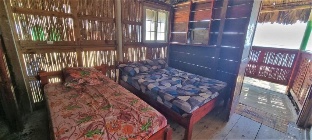 Postel nebo postele na pokoji v ubytování Cabaña privada en las islas de San blas Aroma