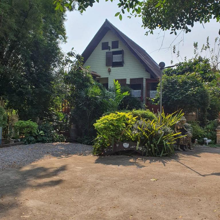 a house with a lot of plants in front of it at Sandy Lake 2012 in Kaeng Krachan