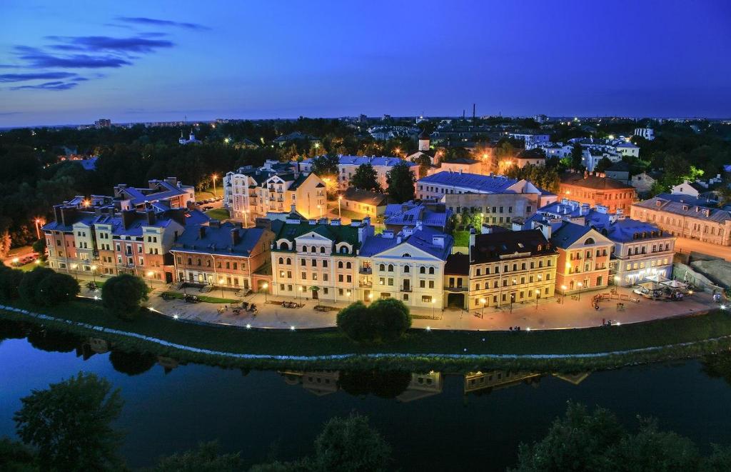 an aerial view of a large building at night at Golden Embankment in Pskov