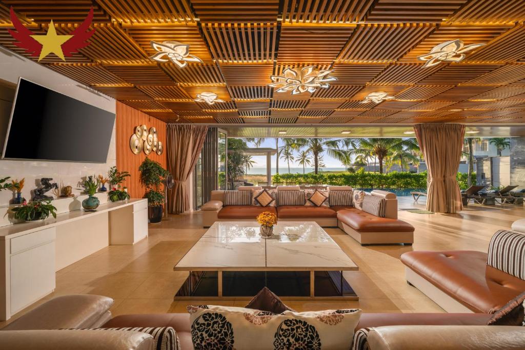 a living room with couches and a table at The Five Stars Villa 8 Bedrooms Beachfront in Danang