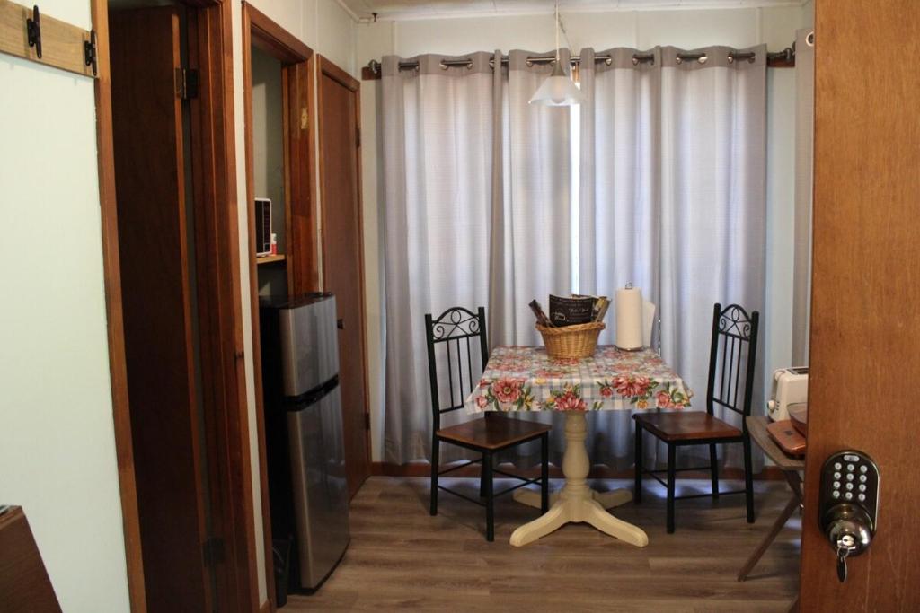 a dining room with a table and chairs and a television at Guest House in Hemphill