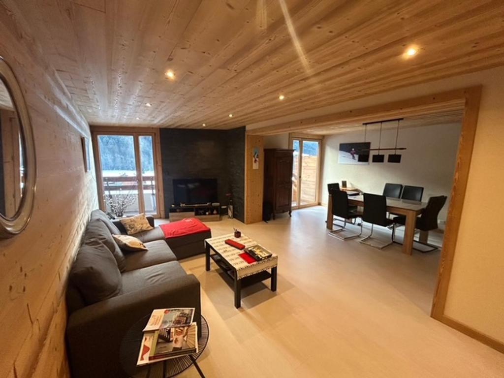 un salon avec un canapé et une table dans l'établissement Appartement spacieux avec balcon sud et parking couvert - FR-1-692-110, à La Chapelle-dʼAbondance