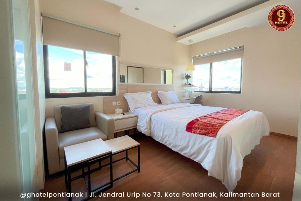 Postel nebo postele na pokoji v ubytování G-Hotel Pontianak