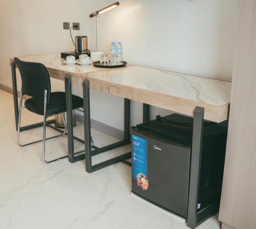 a desk in a room with a chair and a table at NS Royal Hotel in Cebu City