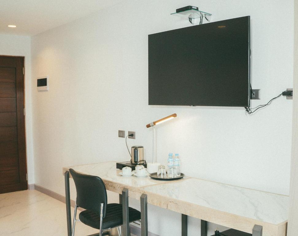 a table with chairs and a blackboard on a wall at NS Royal Hotel in Cebu City