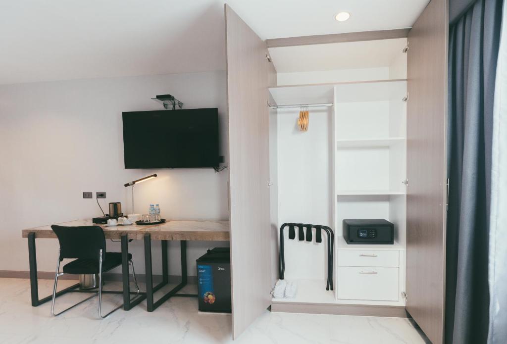 a dining room with a table and a desk at NS Royal Hotel in Cebu City
