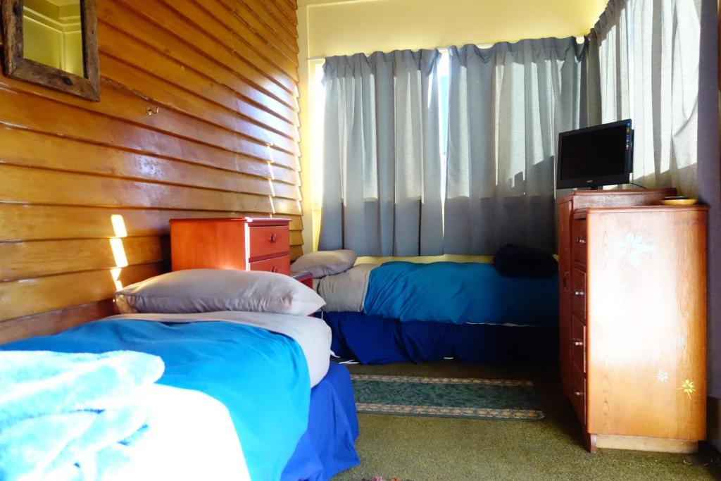 Postel nebo postele na pokoji v ubytování Big Tree Lodge Methven