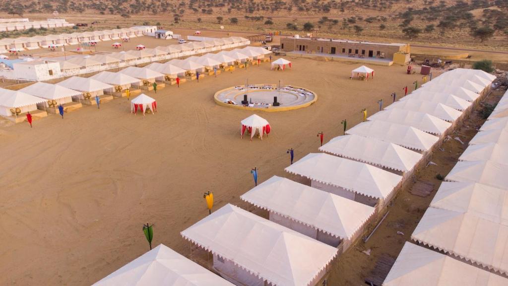 an aerial view of a building with white tents at Golden Empire Desert Camp in Jaisalmer