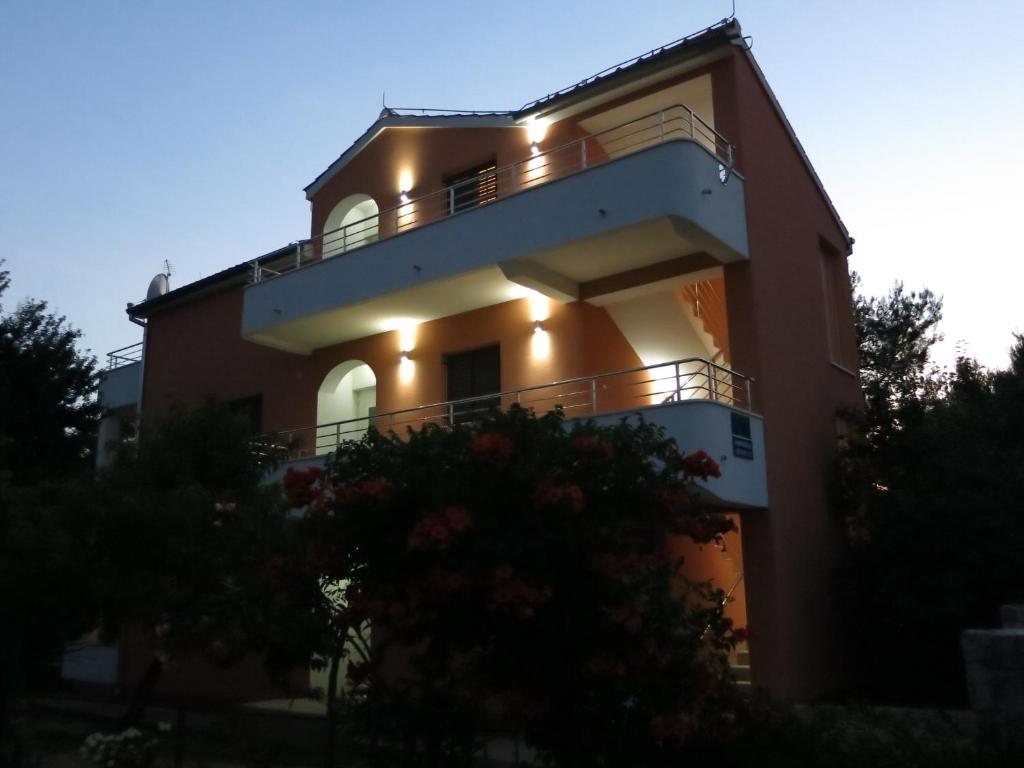 a large house with lights on the side of it at Apartment Mario in Vodice