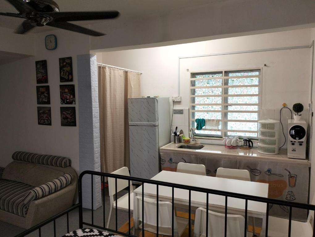 a kitchen with a table and chairs in a room at lost world of tambun homestay in Ipoh