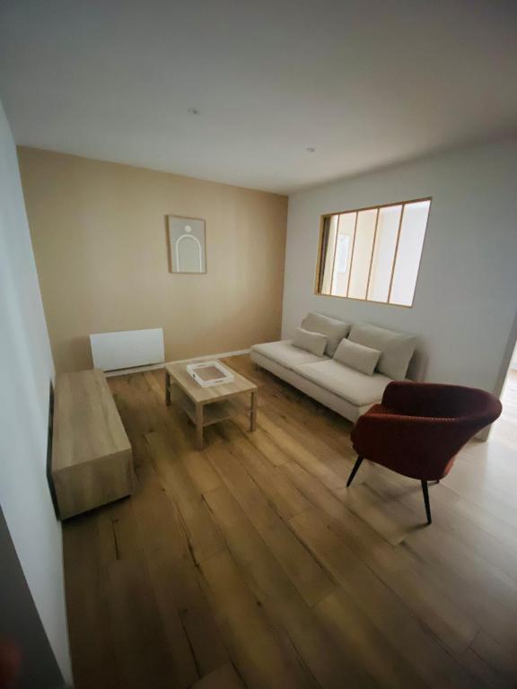 un salon avec un canapé et une table dans l'établissement Spacieux appartement avec terrasse, à Châtellerault