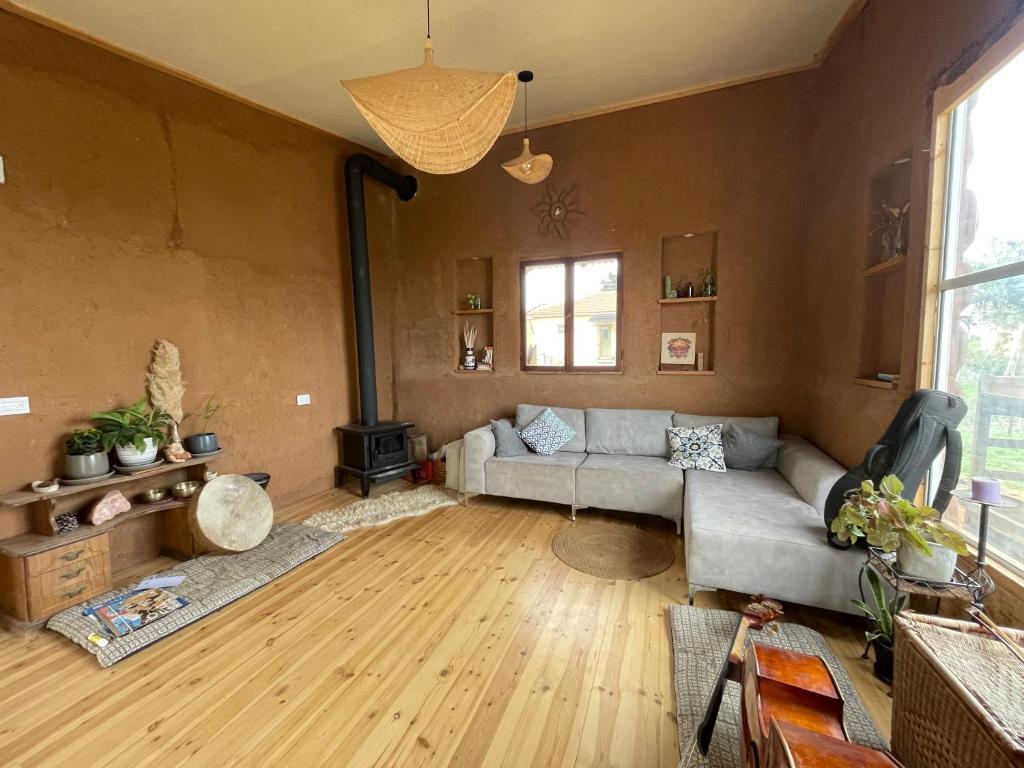 a living room with a couch and a wood floor at על ראש הגבעה- משק 68 in Ilaniya