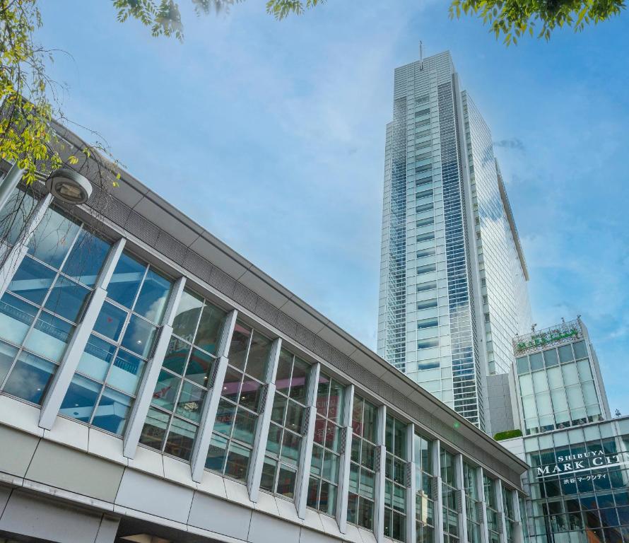 a building with two tall buildings in the background at Shibuya Excel Hotel Tokyu in Tokyo