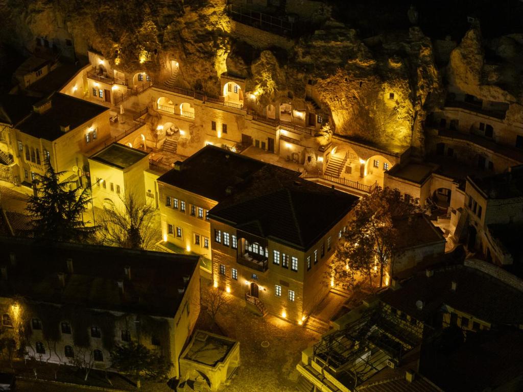 a group of buildings on a mountain at night at Asmalı Konak Cave Suites of Cappadocia in Ürgüp