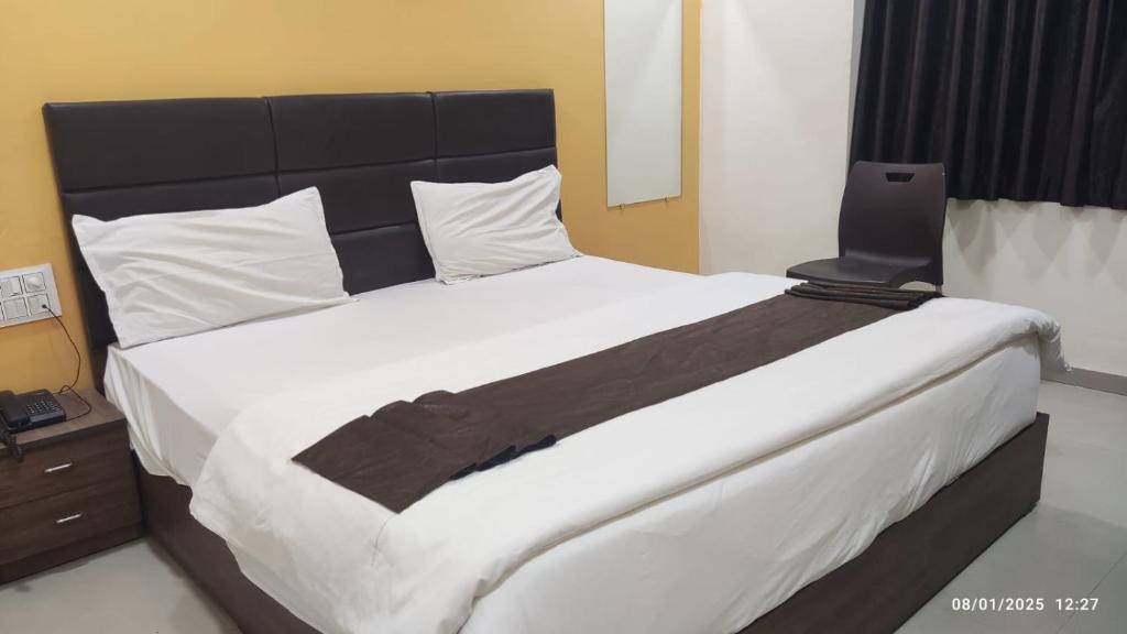 Postel nebo postele na pokoji v ubytování The Riddhi Hotel