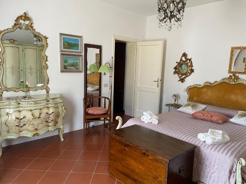 a bedroom with a bed and a dresser and a mirror at 'Il Casale di Giova' Tuscan Farmhouse in Lucca