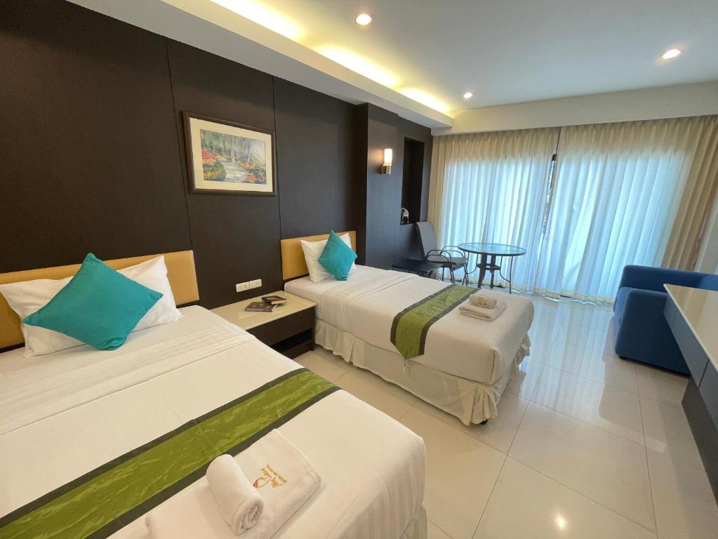 Postel nebo postele na pokoji v ubytování My PLACE HUA-HIN HOTEL