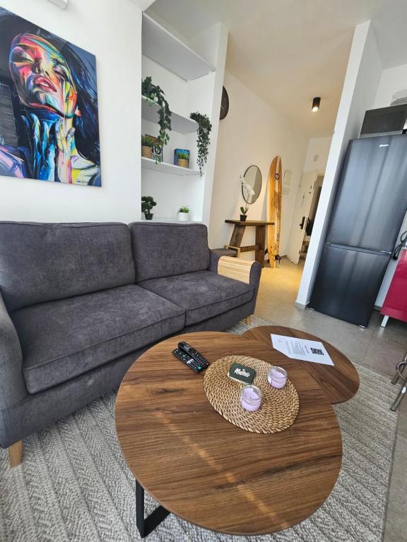 a living room with a couch and a table at Hayarkon Superior TLV Beach 7B in Tel Aviv