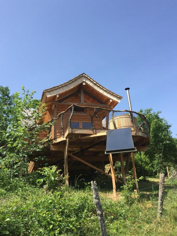 une cabane dans les arbres au milieu d'un champ dans l'établissement Cabane insolite Les Vargottes, à Le Val-dʼAjol