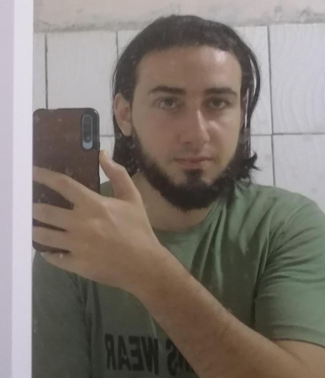 a man taking a picture of himself in a mirror at شقه مفروشه in Maḩaţţat Quwaysinā