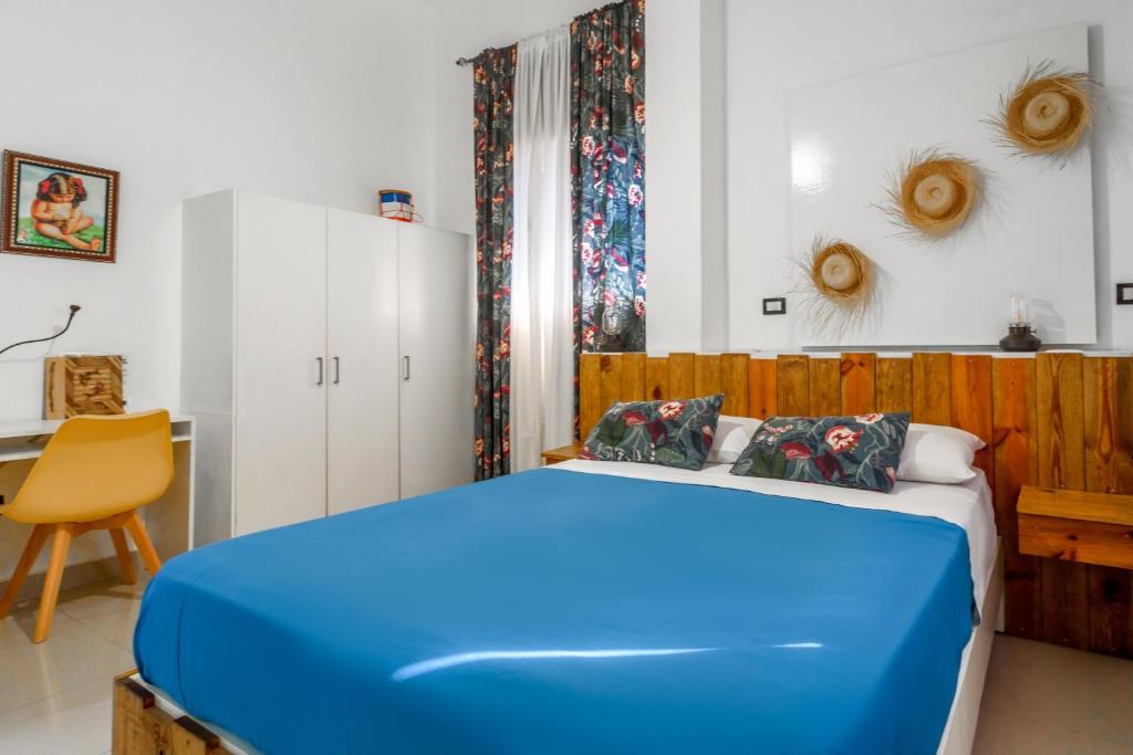 Postel nebo postele na pokoji v ubytování Hostal Mamà Mambò - Zona Colonial