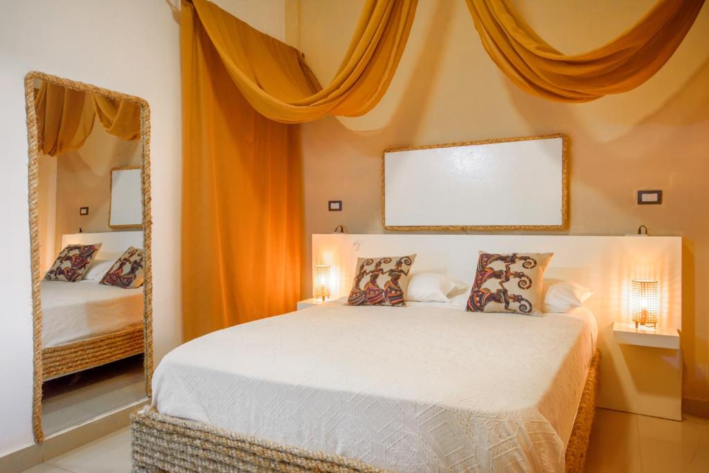 Postel nebo postele na pokoji v ubytování Hostal Mamà Mambò - Zona Colonial