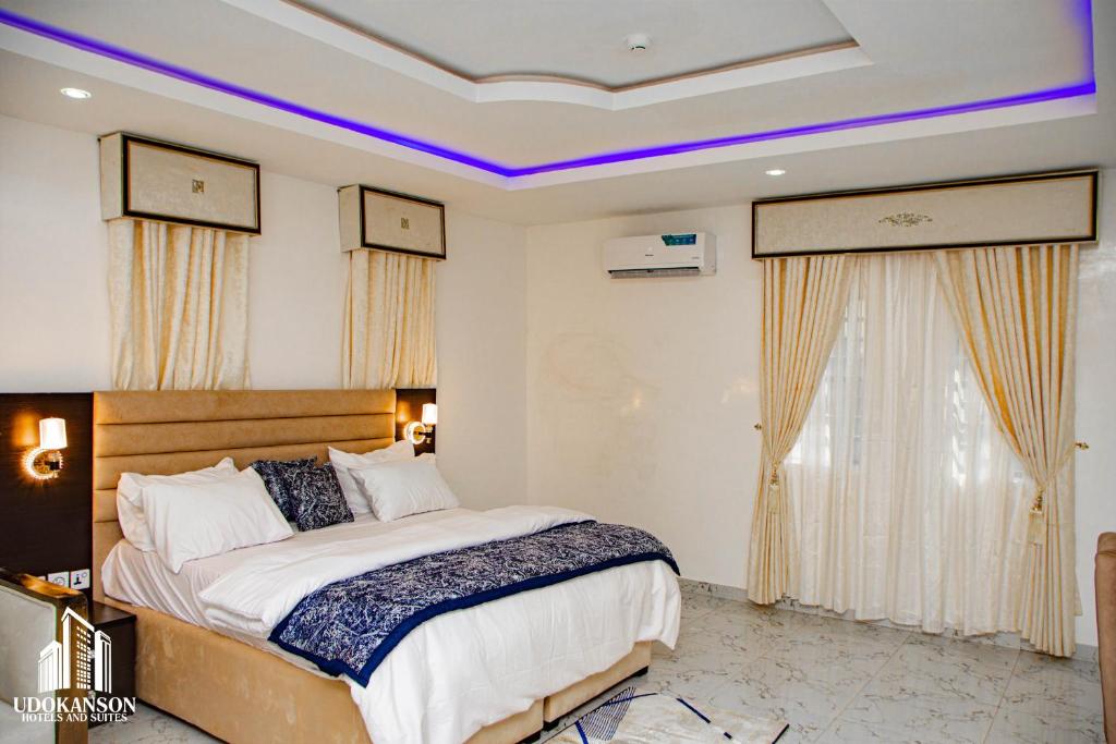 a bedroom with a large bed in a room at Udokanson Hotel And Suites in Agbor