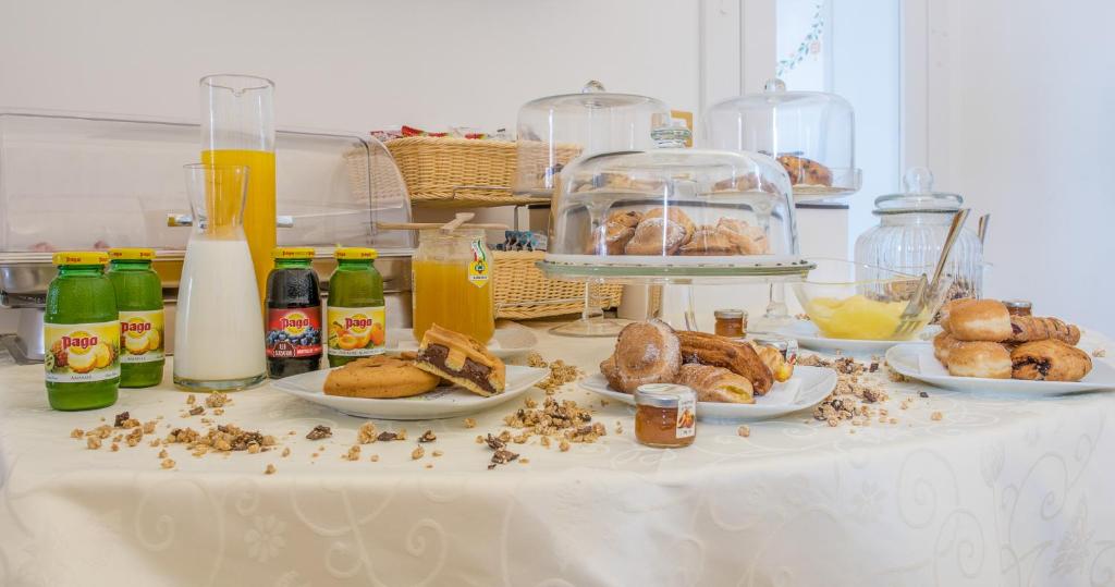 a table with plates of food and bottles of milk at Dimora Dell'Osanna in Carovigno