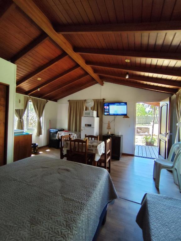 a bedroom with a bed and a table and a television at Fusión Natural in Playa Verde