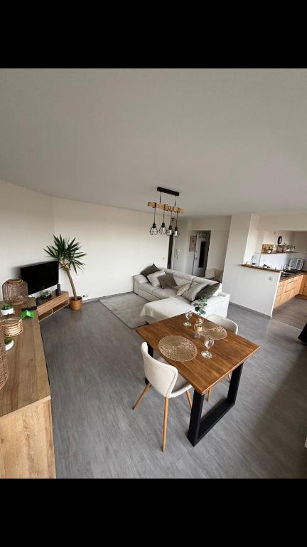 a living room with a table and a couch at Air Bey Penthouse in Brussels