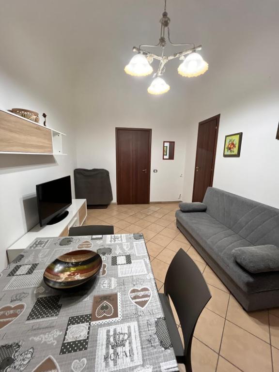 a living room with a table and a couch at House del Corso Calatafimi in Palermo