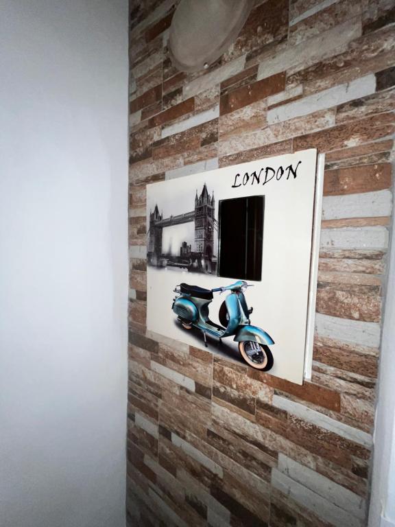 a picture of a scooter on a brick wall at House del Corso Calatafimi in Palermo